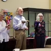 5 people holding different puppets while a sixth person demonstrates how to move the puppets